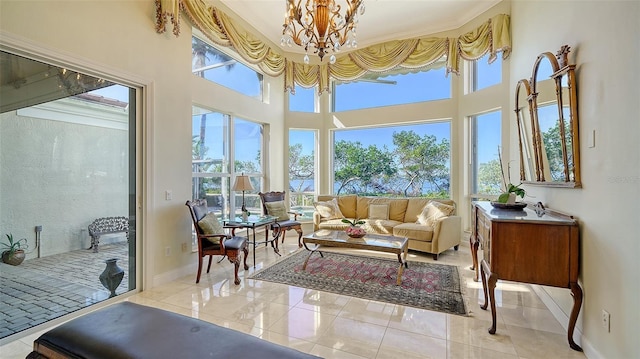 sunroom / solarium with a healthy amount of sunlight and an inviting chandelier