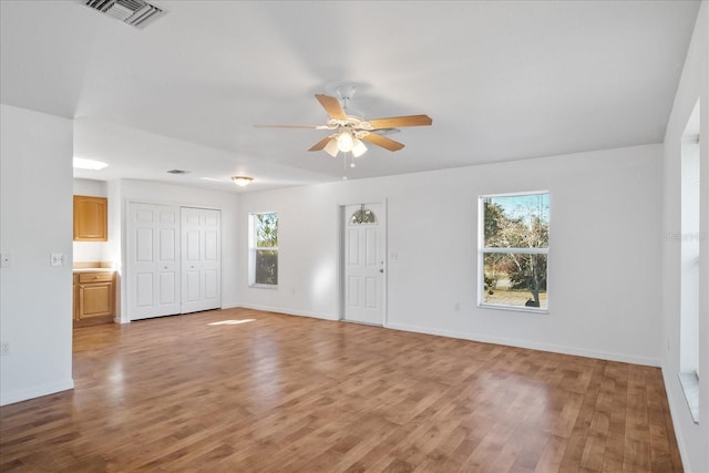 spare room with hardwood / wood-style flooring and ceiling fan