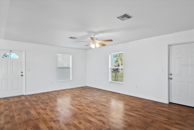 foyer with dark hardwood / wood-style floors, a wealth of natural light, and ceiling fan