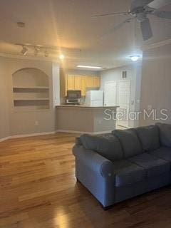 living room featuring hardwood / wood-style flooring and ceiling fan