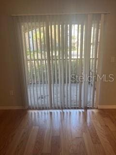 unfurnished room with hardwood / wood-style floors