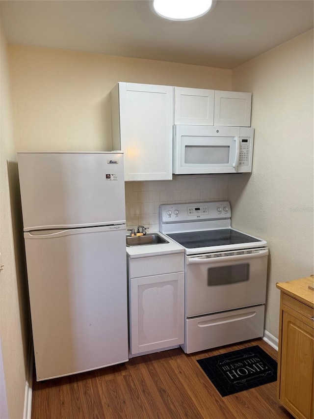 kitchen featuring white cabinets, white appliances, dark hardwood / wood-style floors, and backsplash