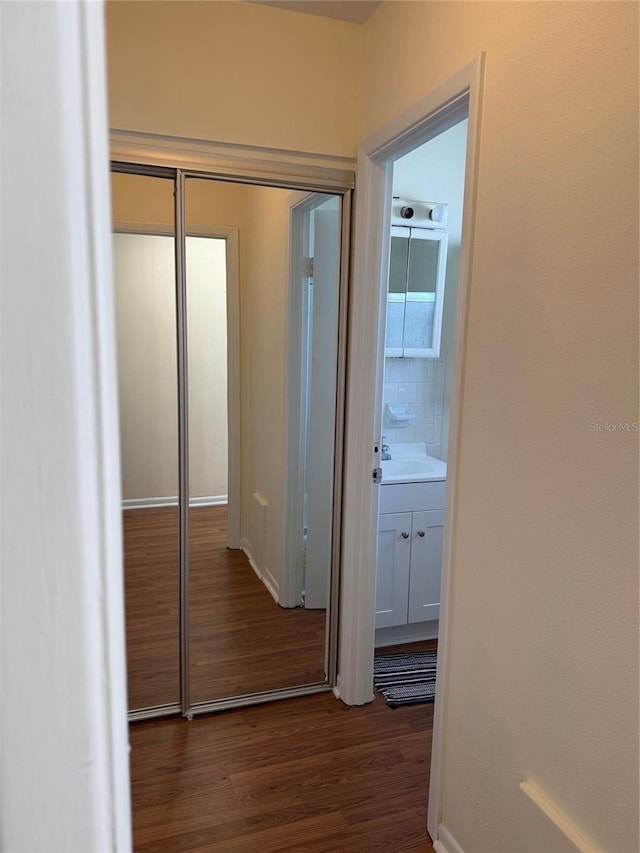 corridor with dark wood-type flooring