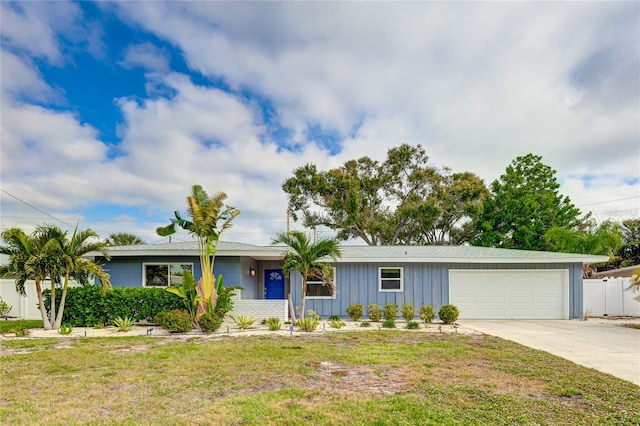 single story home featuring a garage and a front lawn