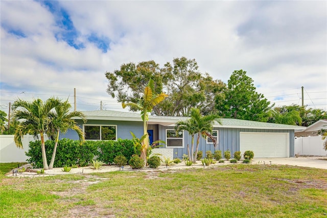 ranch-style home with a front lawn and a garage