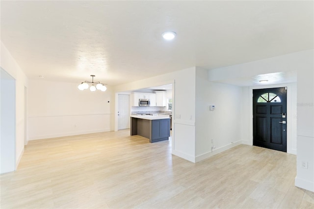 foyer featuring a notable chandelier and light wood-type flooring