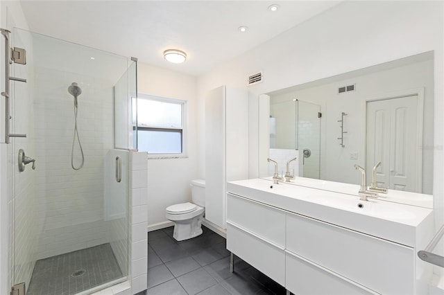 bathroom with tile patterned flooring, vanity, toilet, and walk in shower