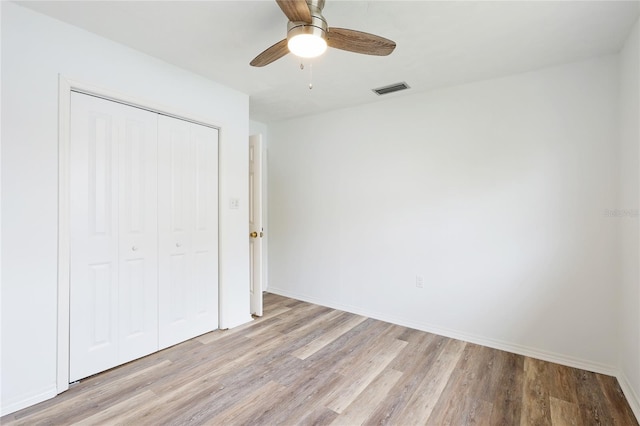 unfurnished bedroom with a closet, ceiling fan, and light hardwood / wood-style flooring