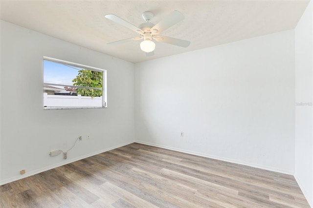 empty room with ceiling fan and light wood-type flooring