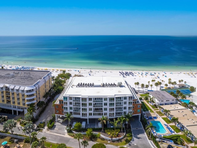 birds eye view of property with a water view and a beach view