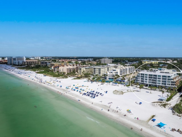 birds eye view of property featuring a water view and a beach view