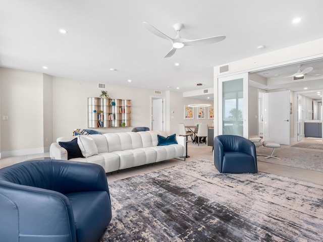 living room with wood-type flooring and ceiling fan