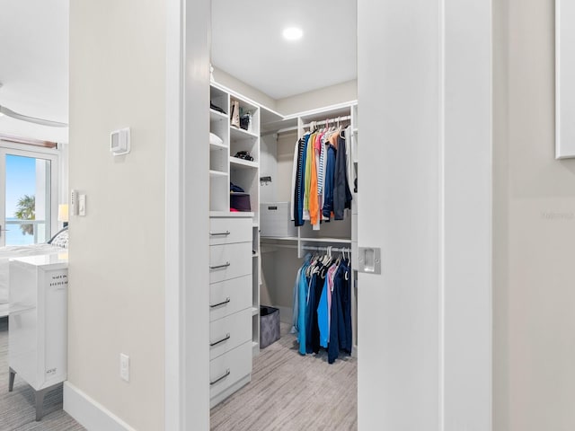 spacious closet featuring light hardwood / wood-style floors