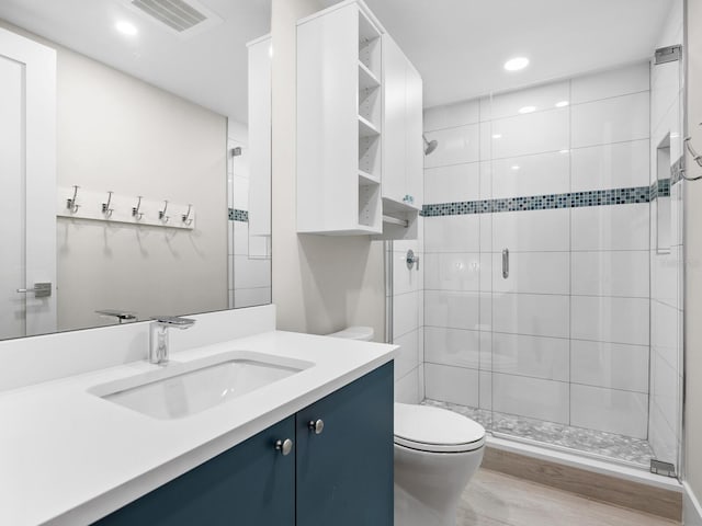 bathroom with vanity, walk in shower, and toilet