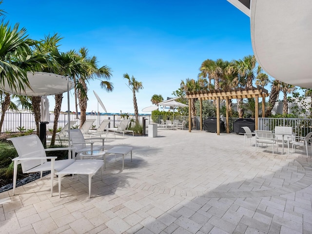 view of patio / terrace with a jacuzzi and a pergola