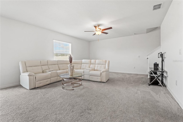 carpeted living room with ceiling fan