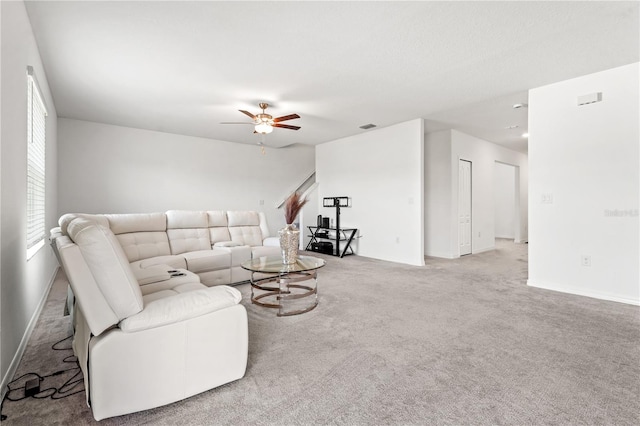 living room with ceiling fan and carpet