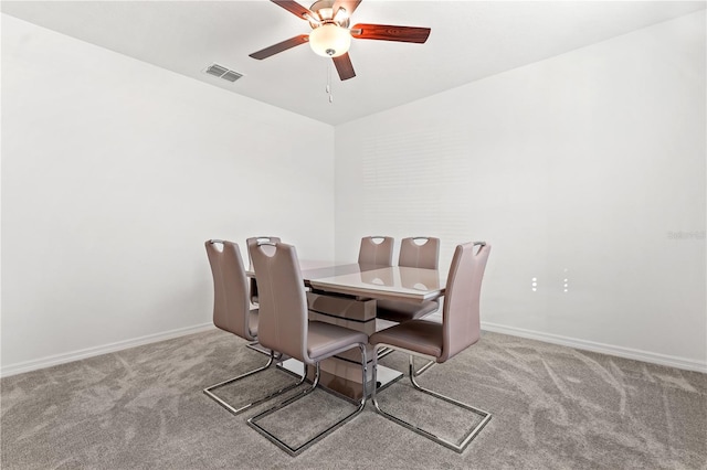 dining room featuring ceiling fan and light carpet