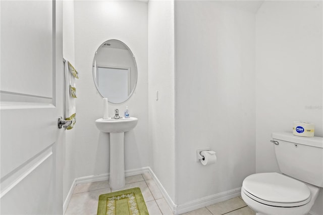 bathroom featuring tile patterned flooring and toilet