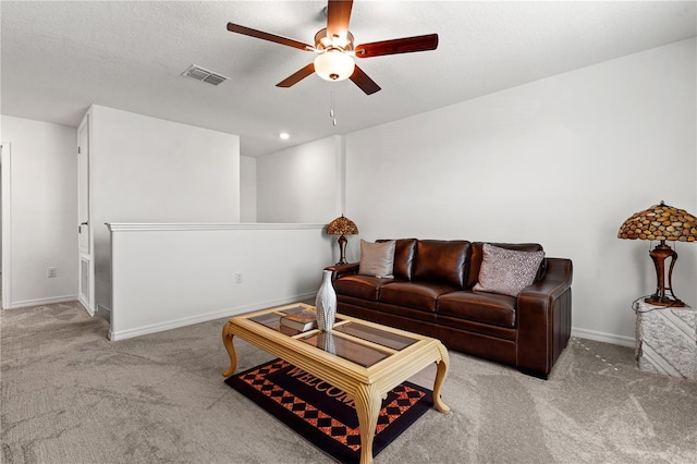 living room featuring carpet flooring and ceiling fan