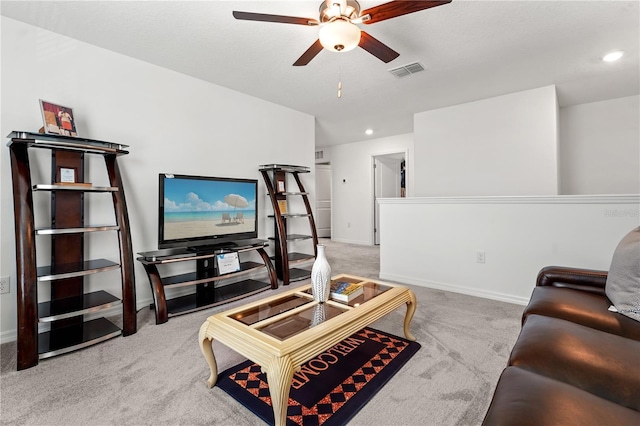 carpeted living room with ceiling fan