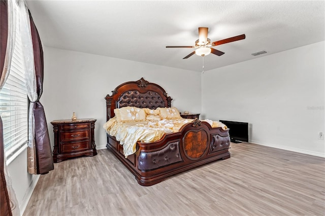 bedroom featuring ceiling fan and light hardwood / wood-style floors