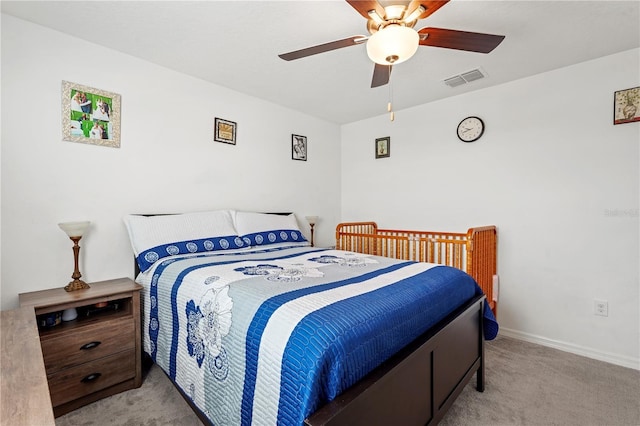 bedroom with ceiling fan and light colored carpet