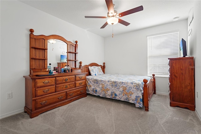 bedroom with ceiling fan and light colored carpet