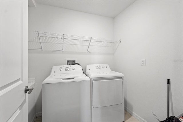 clothes washing area with independent washer and dryer