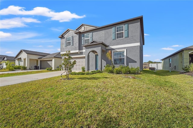 traditional-style home featuring a front yard, driveway, an attached garage, and stucco siding