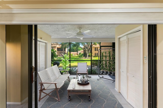 unfurnished sunroom featuring ceiling fan