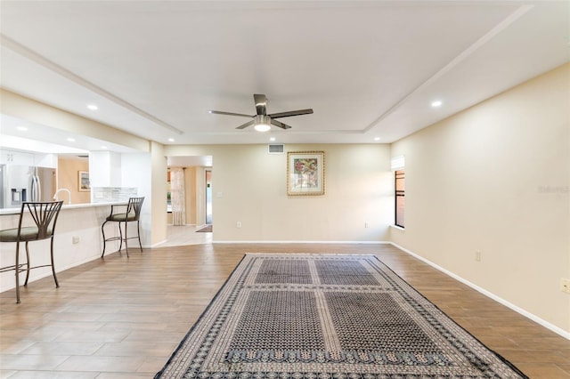 unfurnished living room featuring ceiling fan and light hardwood / wood-style floors