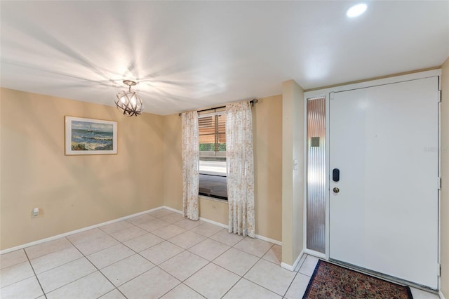 tiled entryway featuring an inviting chandelier