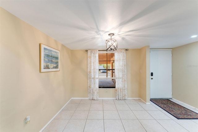 unfurnished dining area with light tile patterned floors and a chandelier