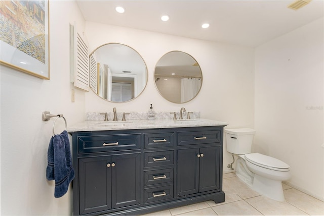 bathroom featuring tile patterned floors, vanity, and toilet