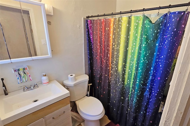 bathroom featuring vanity, curtained shower, and toilet