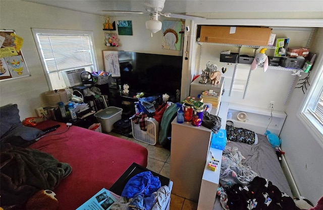 interior space with multiple windows, ceiling fan, and cooling unit