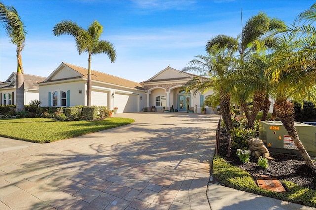 view of front of property featuring a garage and a front lawn