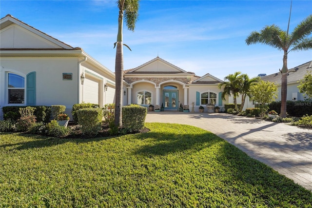 view of front of home with a front yard and a garage