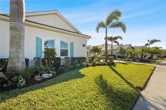 view of side of property with a lawn