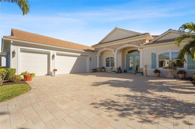 view of front facade featuring french doors and a garage