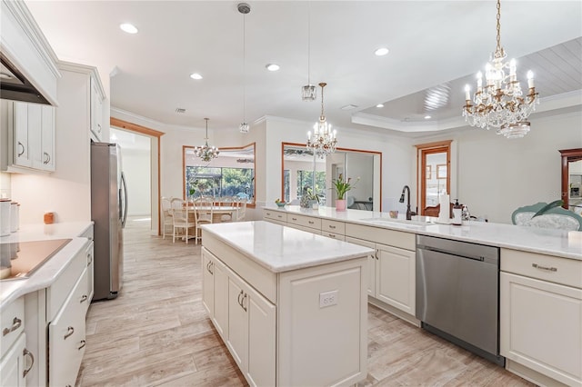 kitchen with a kitchen island, ornamental molding, hanging light fixtures, and appliances with stainless steel finishes