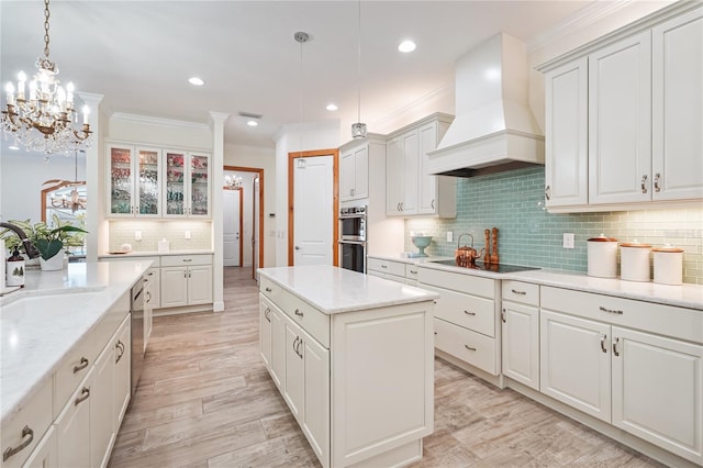 kitchen featuring pendant lighting, tasteful backsplash, a kitchen island, custom range hood, and stainless steel appliances