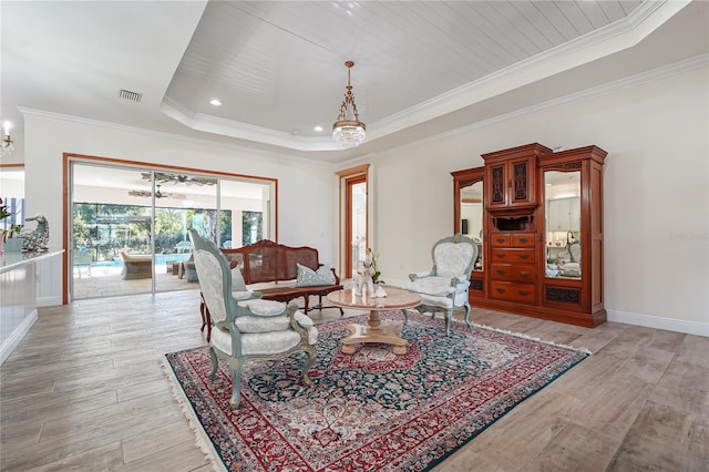 living room with a tray ceiling, wood ceiling, and light wood-type flooring