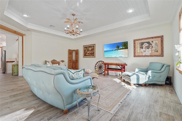 living room with a raised ceiling, a notable chandelier, and crown molding