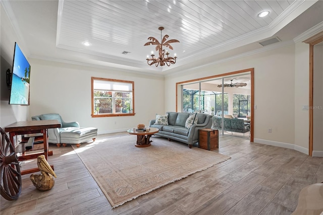 living room with a tray ceiling, wooden ceiling, a chandelier, and ornamental molding