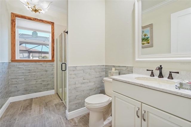 bathroom featuring crown molding, hardwood / wood-style floors, a chandelier, toilet, and vanity