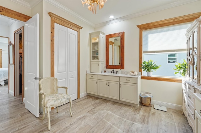 bathroom with vanity, wood-type flooring, a notable chandelier, and ornamental molding