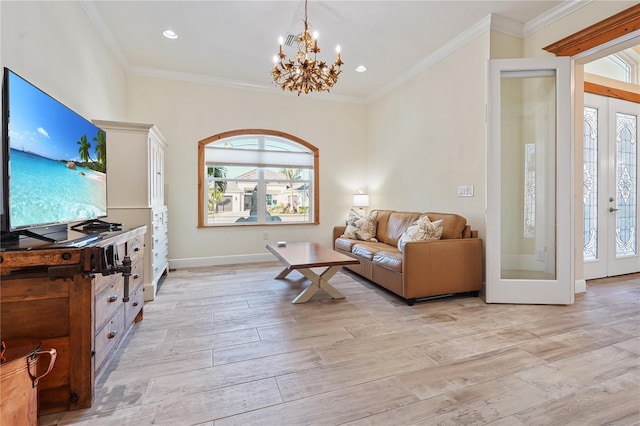 living room featuring crown molding, french doors, a chandelier, and plenty of natural light