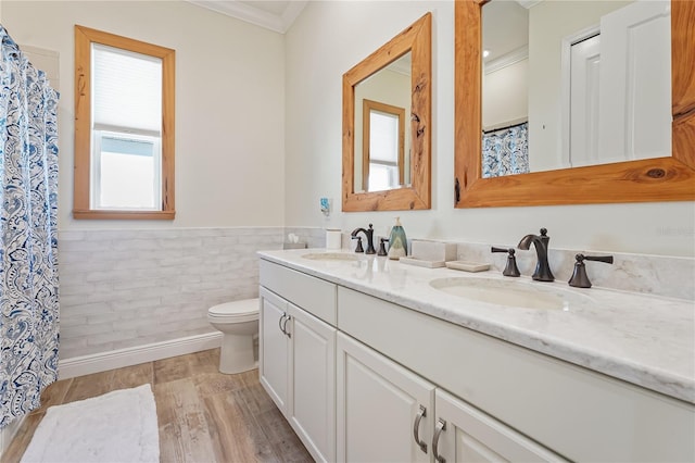 bathroom with hardwood / wood-style floors, vanity, toilet, and crown molding